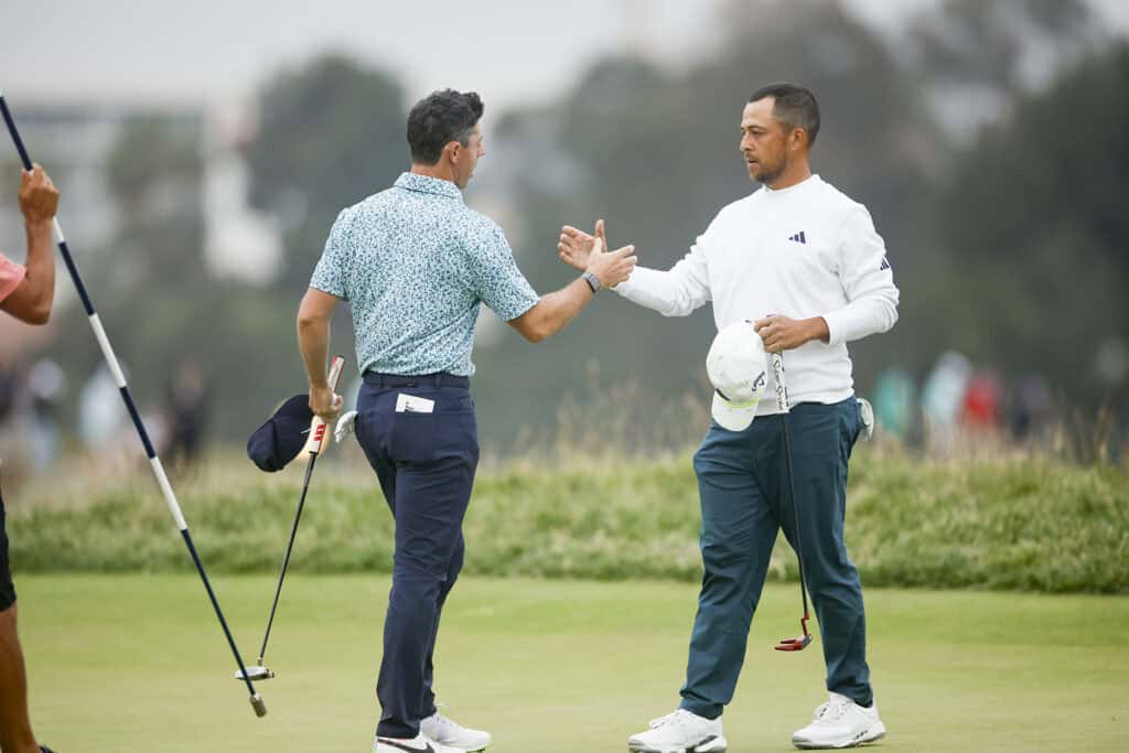 Rory McIlroy and Xander Schauffele shake hands on the 18th green during the third round of the 2023 U.S. Open at The Los Angeles Country Club in Los Angeles, Calif. on Saturday, June 17, 2023. (James Gilbert/USGA)