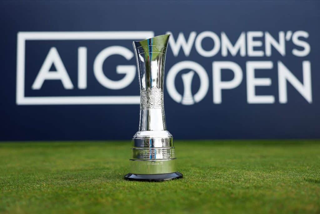 Picture of the AIG Women's Open trophey in front of an AIG Women's Open sign