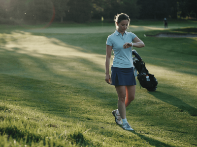 Female golfer looking at watch