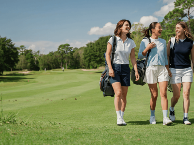 Three women golfer walking on a golf course