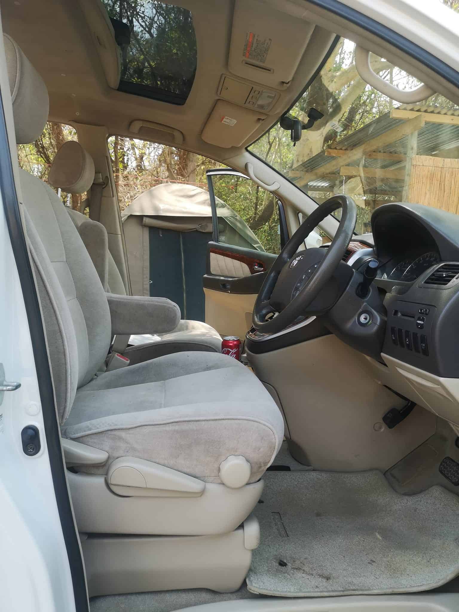 The interior of a car with the driver's seat up.