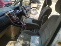 The interior of a vehicle with the driver's seat up.