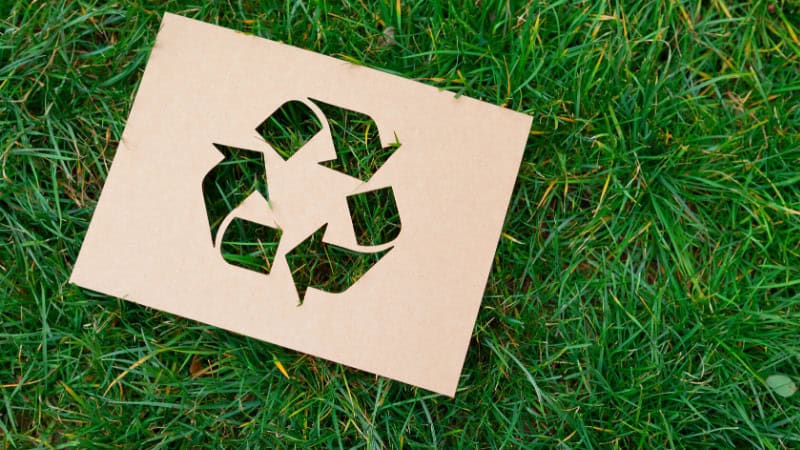 recycling at workit spaces - green grass background with a recycling symbol cutout