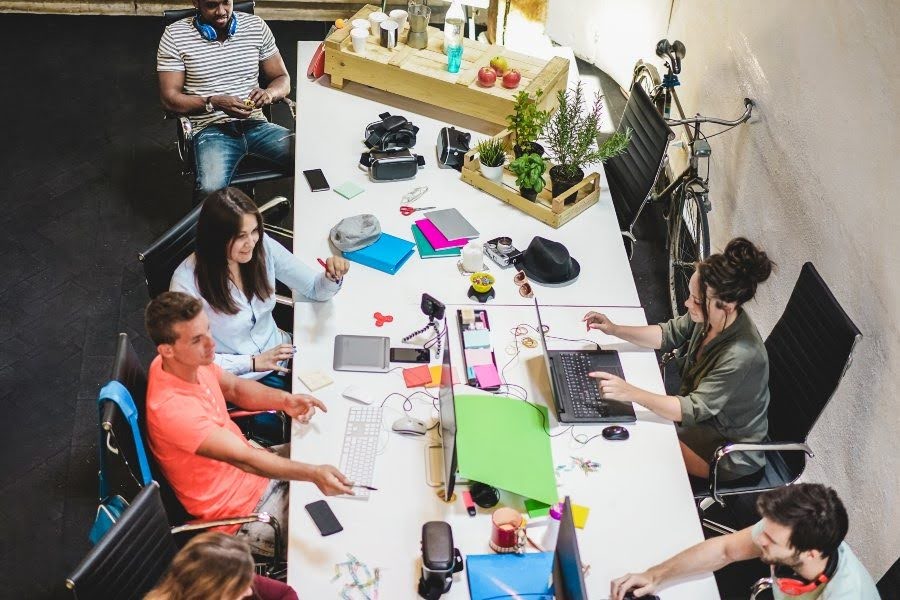 Team collaborating around a table in a bright modern office.