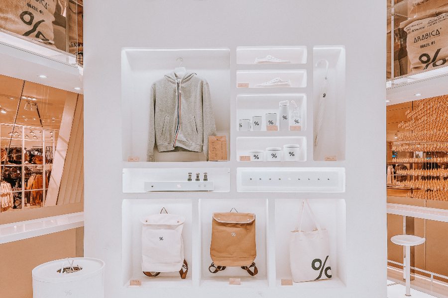 Minimalist pop-up shop display with branded merchandise, apparel and accessories
