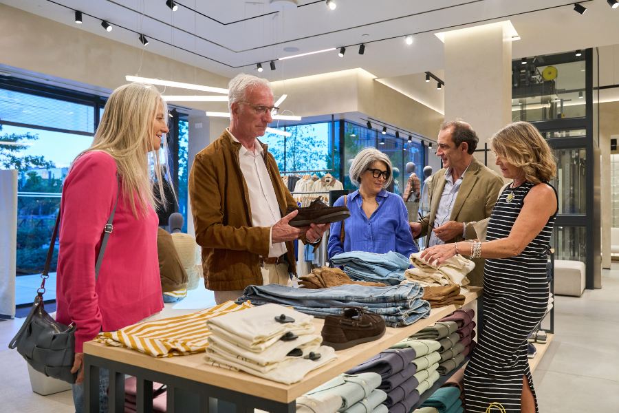 Customers enjoying a personalised experience while browsing clothing in a retail store
