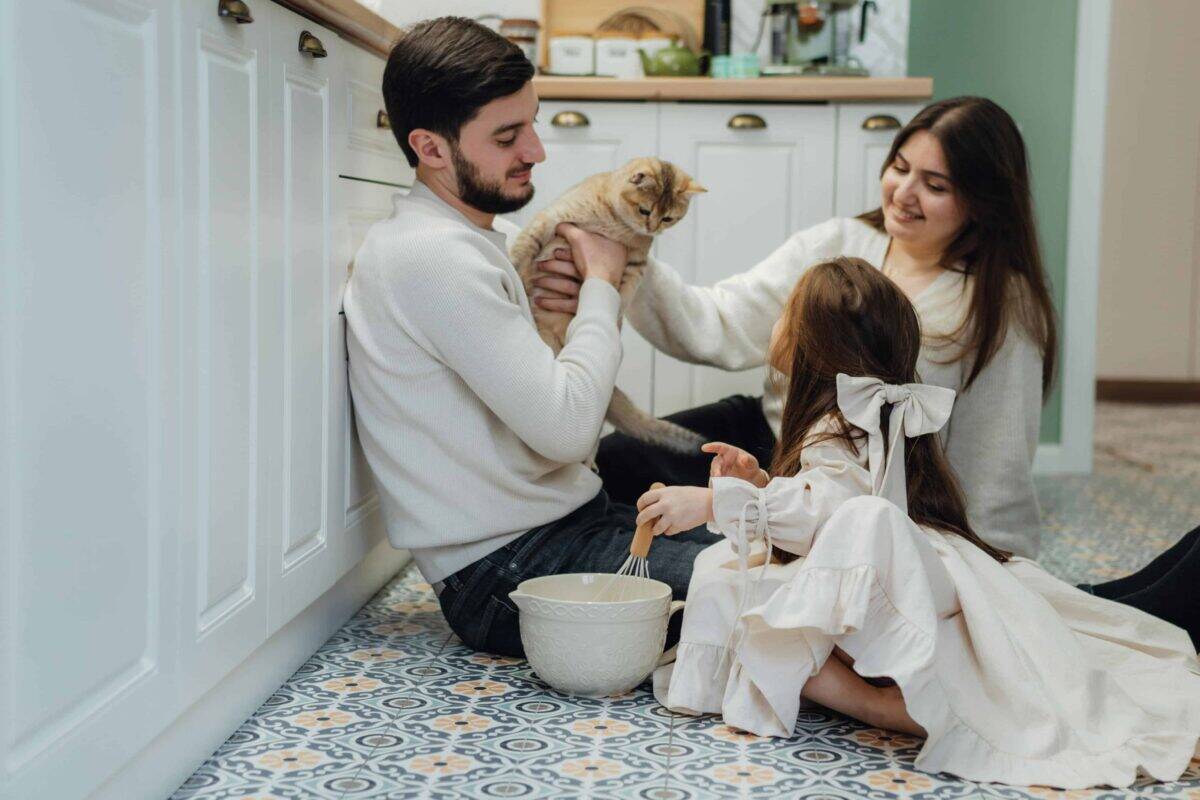 Family bonding at home with their cat during a cozy baking session