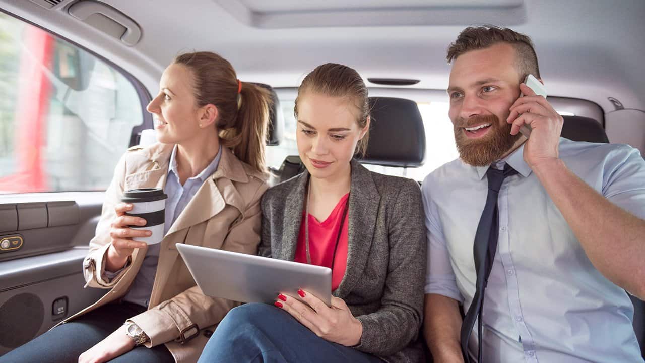 Three work colleagues vanpooling together on the way to the office