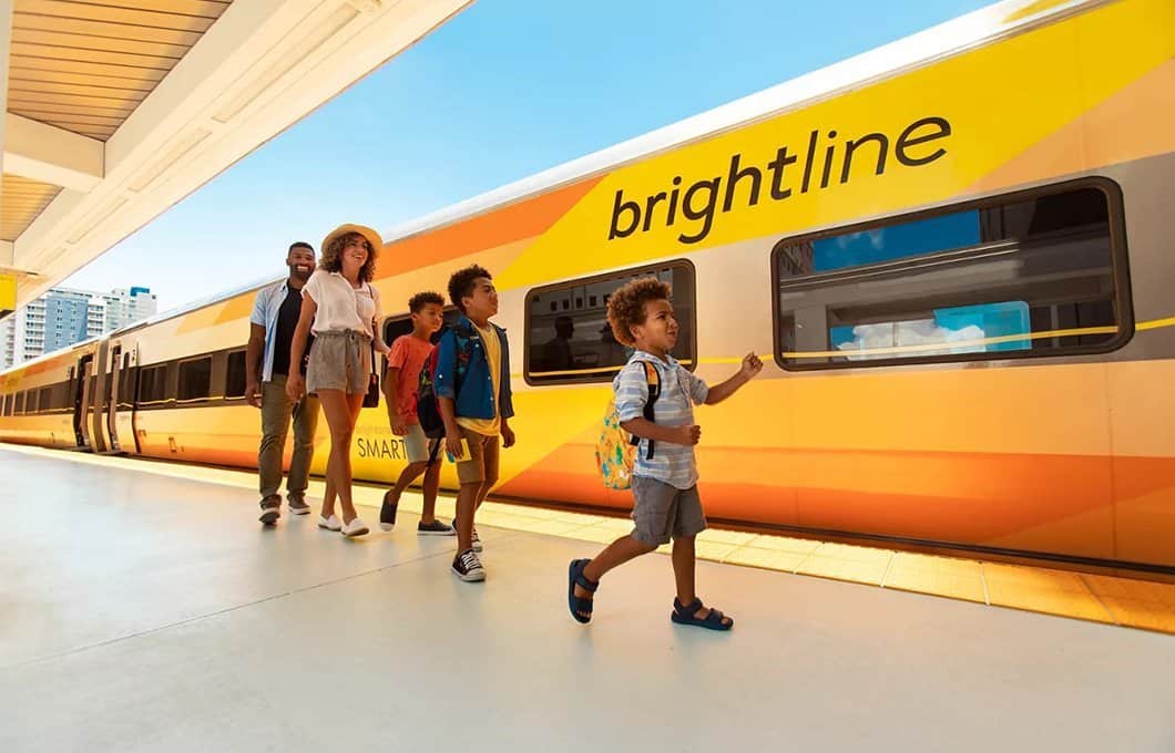 Family pictured in front of a Brightline train