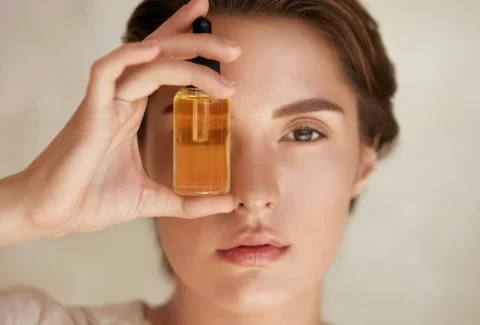 large-main_Woman_With_Bottle_Of_Essential_Oil