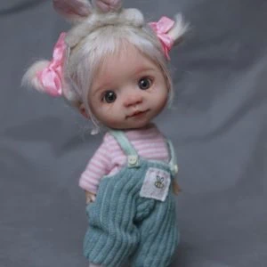 Mia is the doll with blonde hair and pink overalls