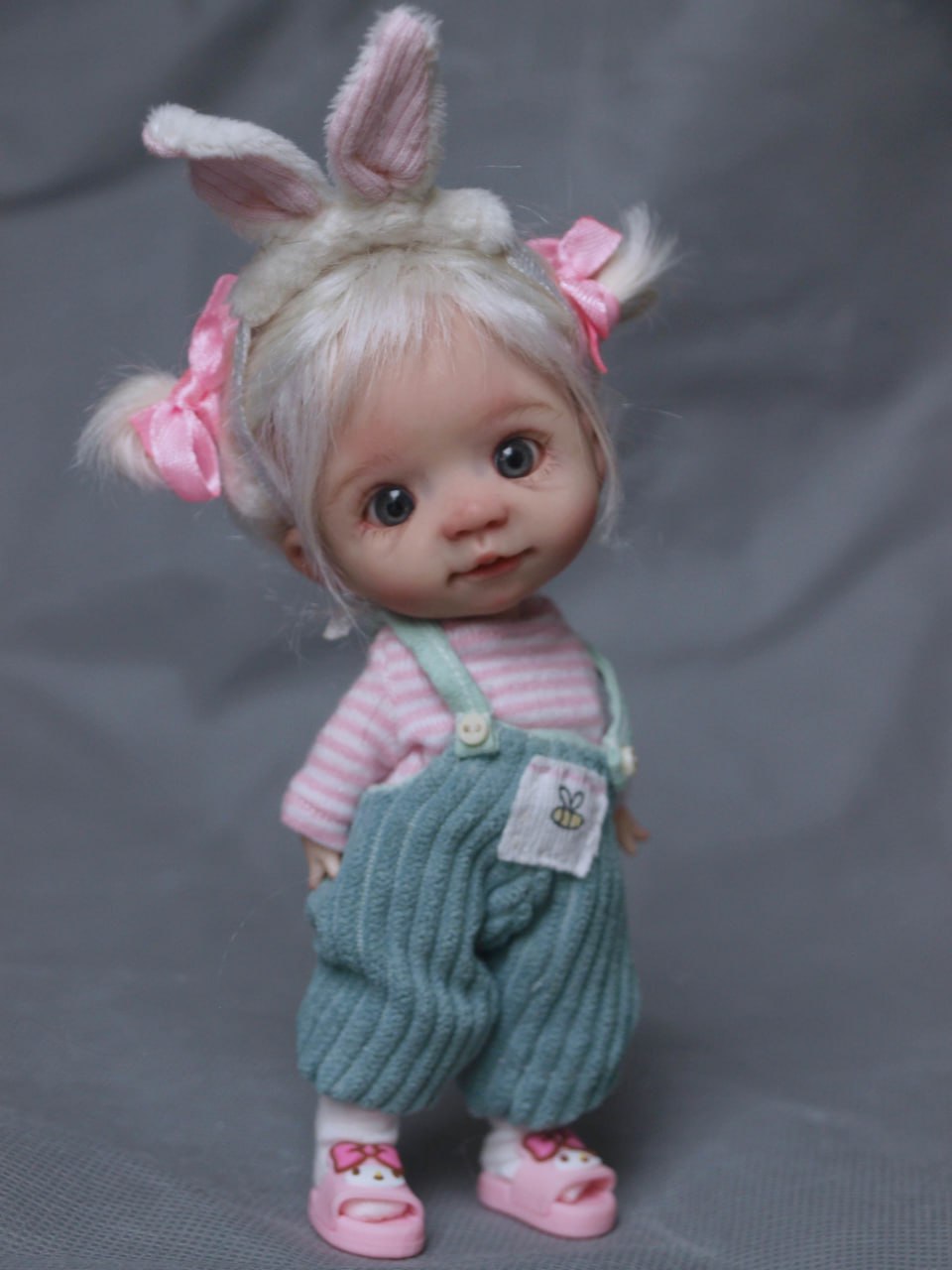 Mia is the doll with blonde hair and pink overalls