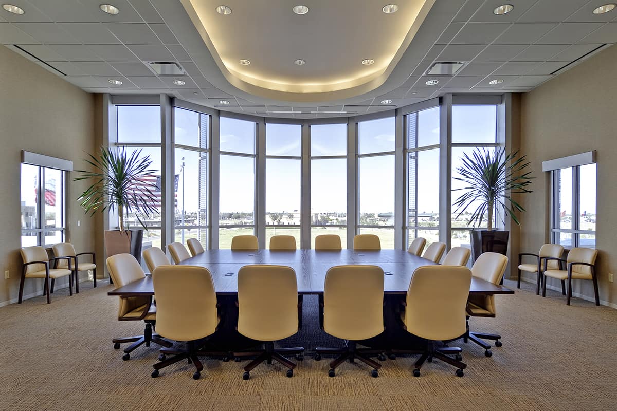 Modern conference room with large table and chairs.