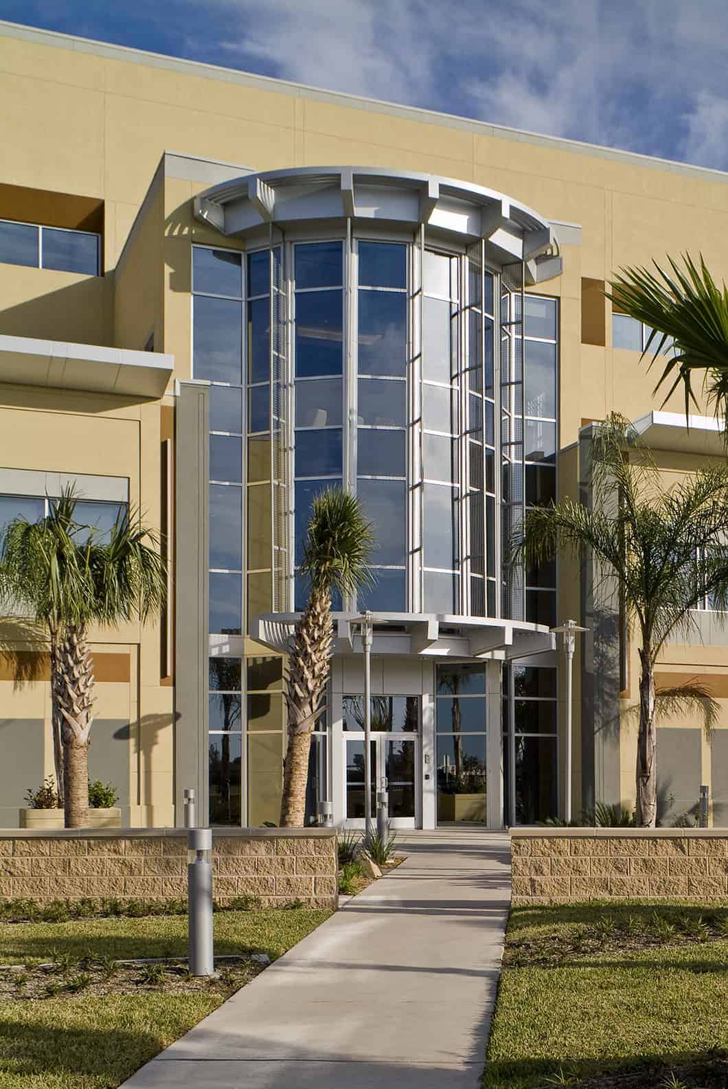 Modern building with palm trees and large windows