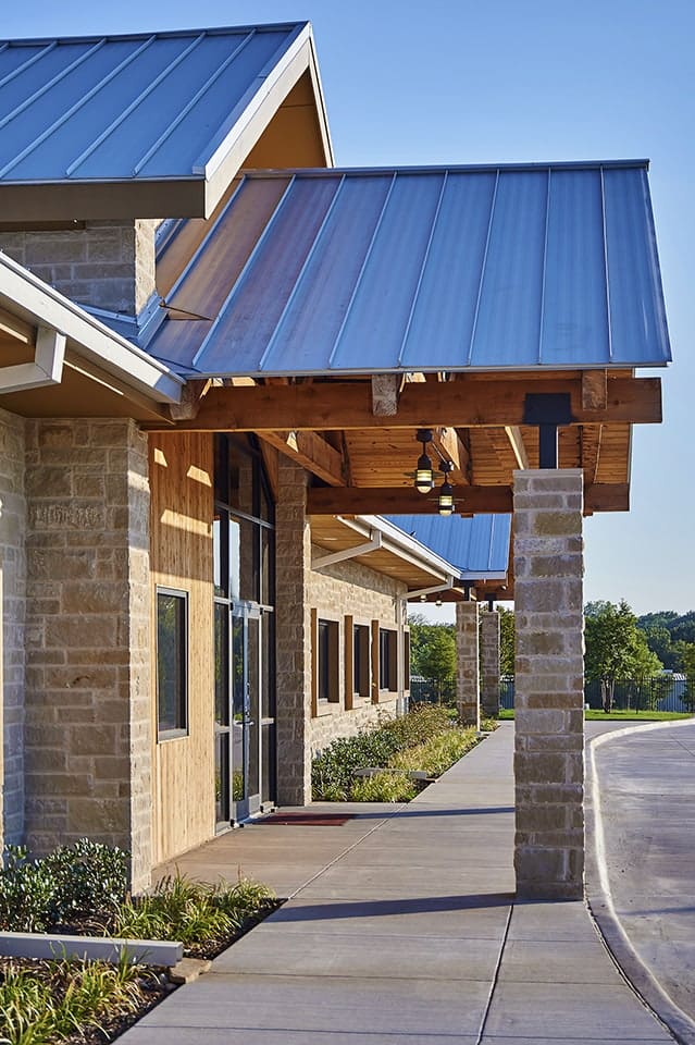 Modern building with metal roof and stone facade