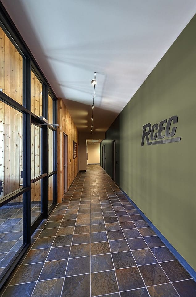 Modern hallway with tiled floor and green wall.