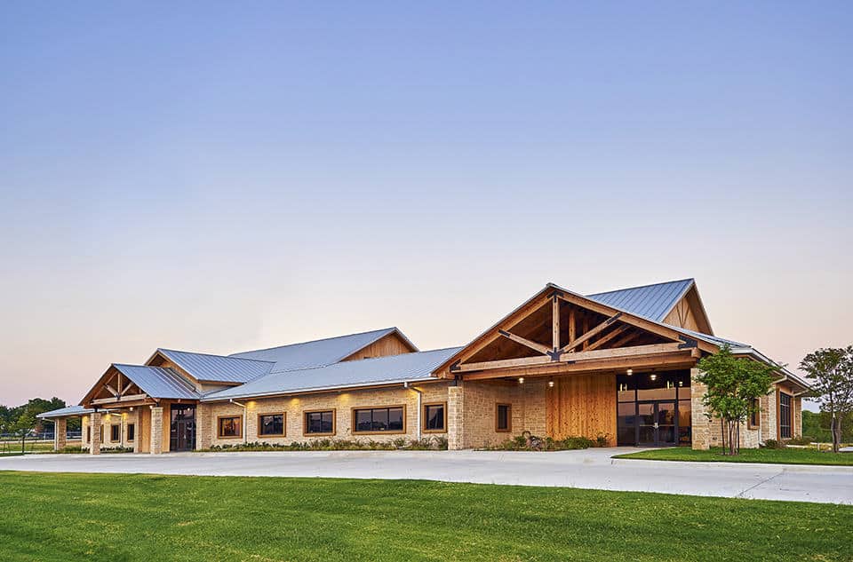 Modern building with wooden exterior and metal roof.