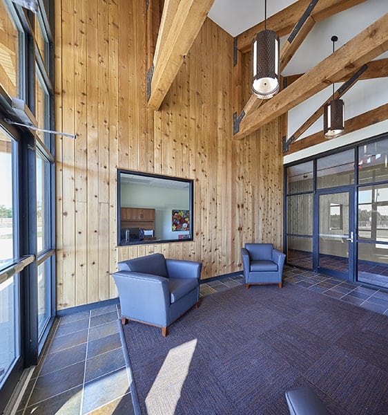 Modern office lobby with wood paneling and chairs