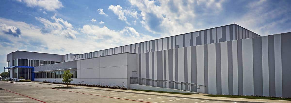 Modern industrial building exterior with cloudy sky
