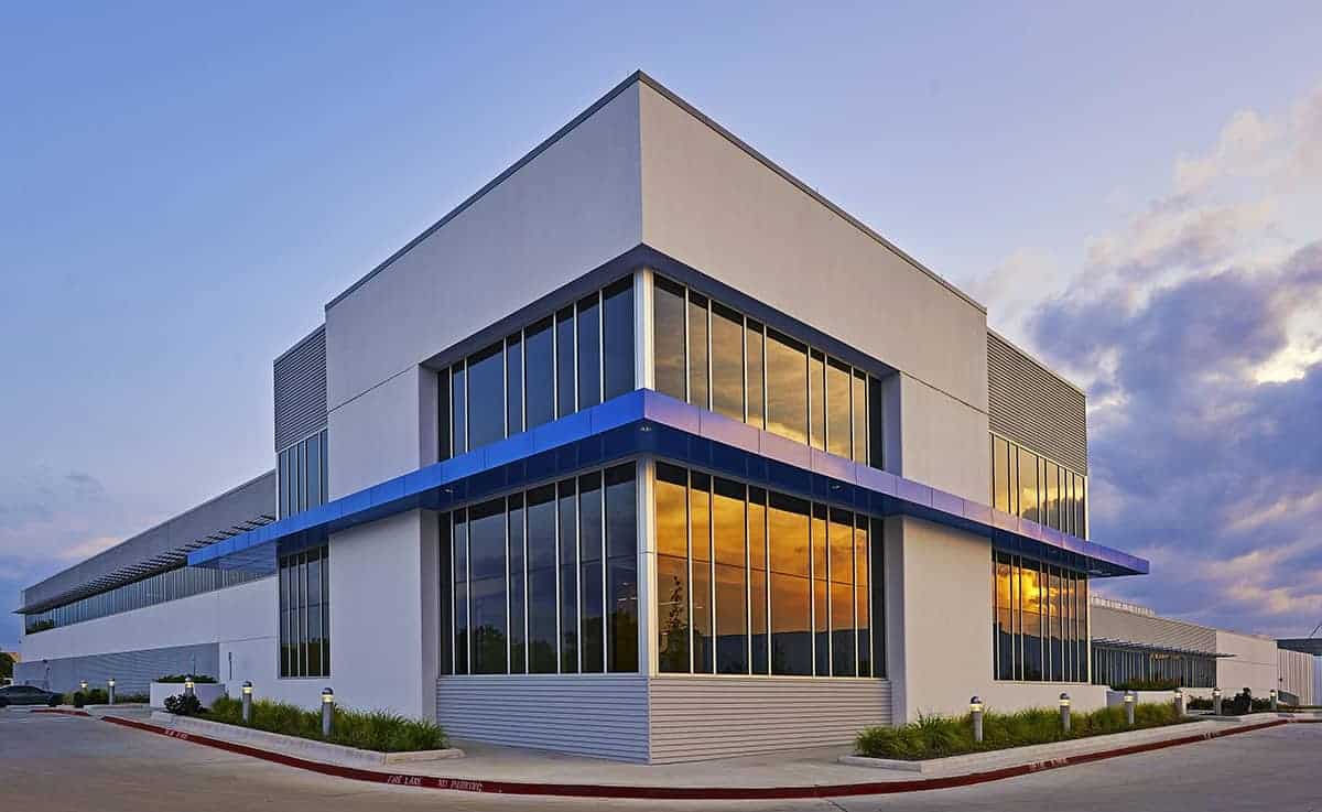 Modern commercial building with glass windows and sleek design by Alliance Architect.