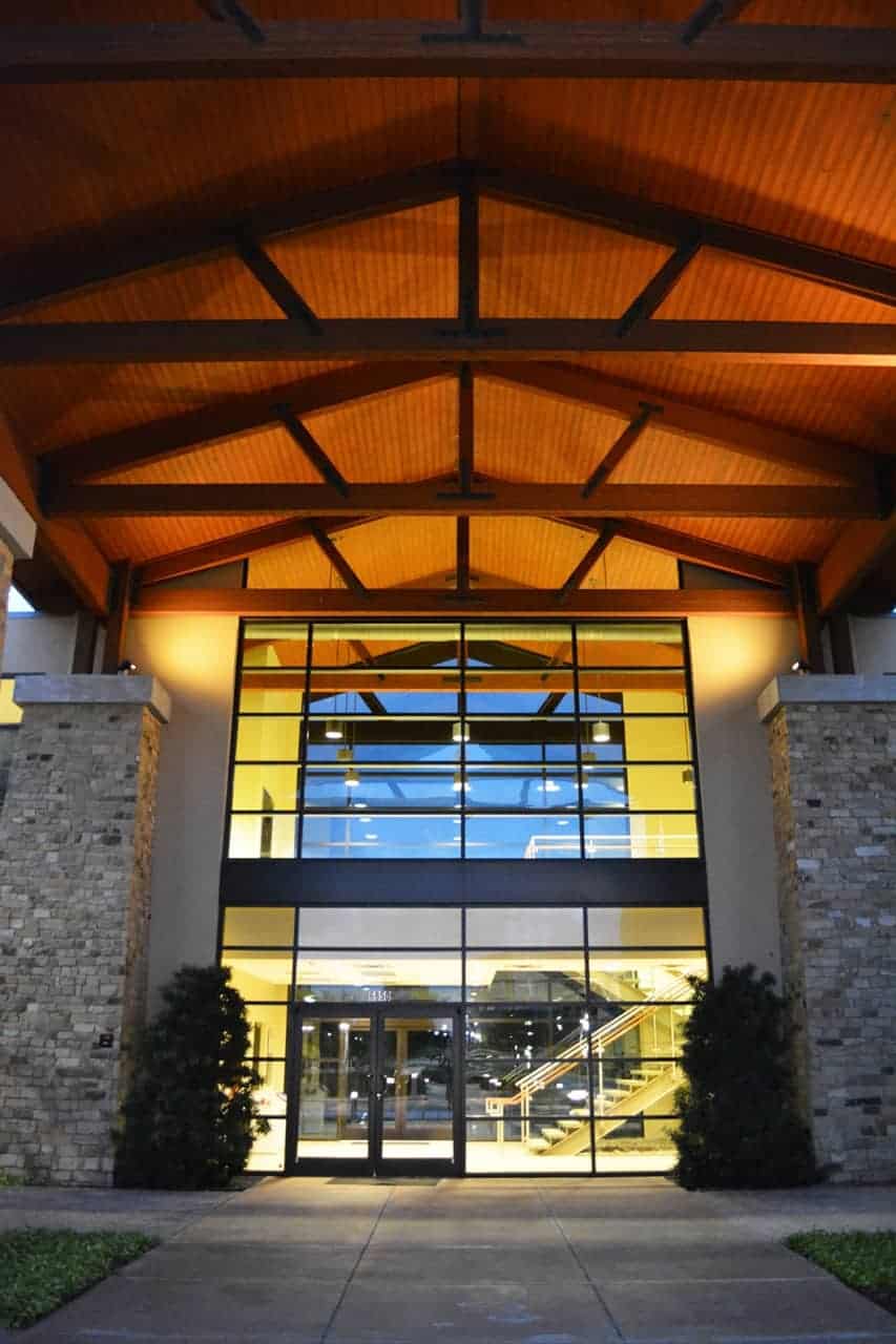 Modern building entrance with glass and wood elements
