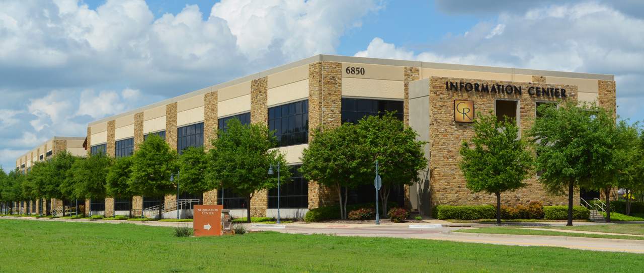 Modern office building with information center sign.