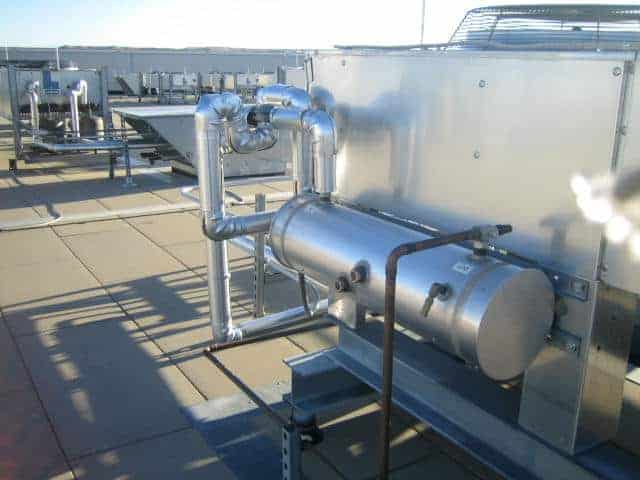 Industrial rooftop HVAC system with pipes and units.
