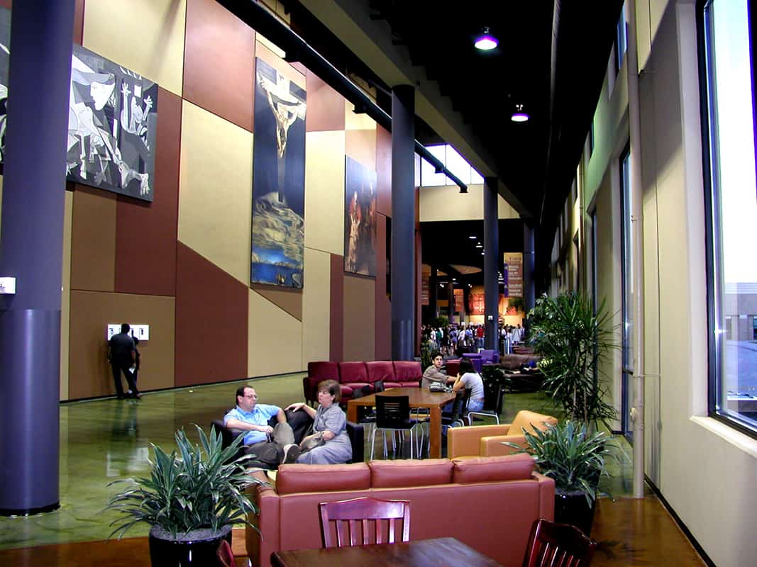 Modern lounge with seating and artwork on walls.