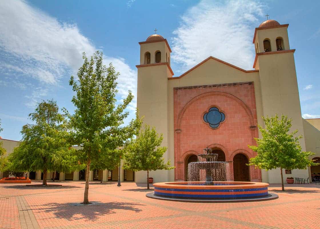 Church courtyard with fountain and trees