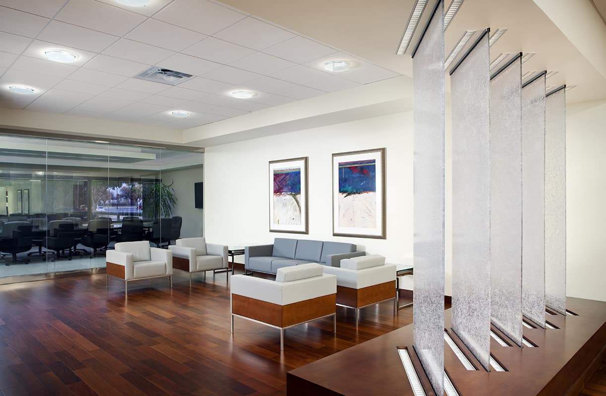 Modern waiting area with chairs and glass panels.