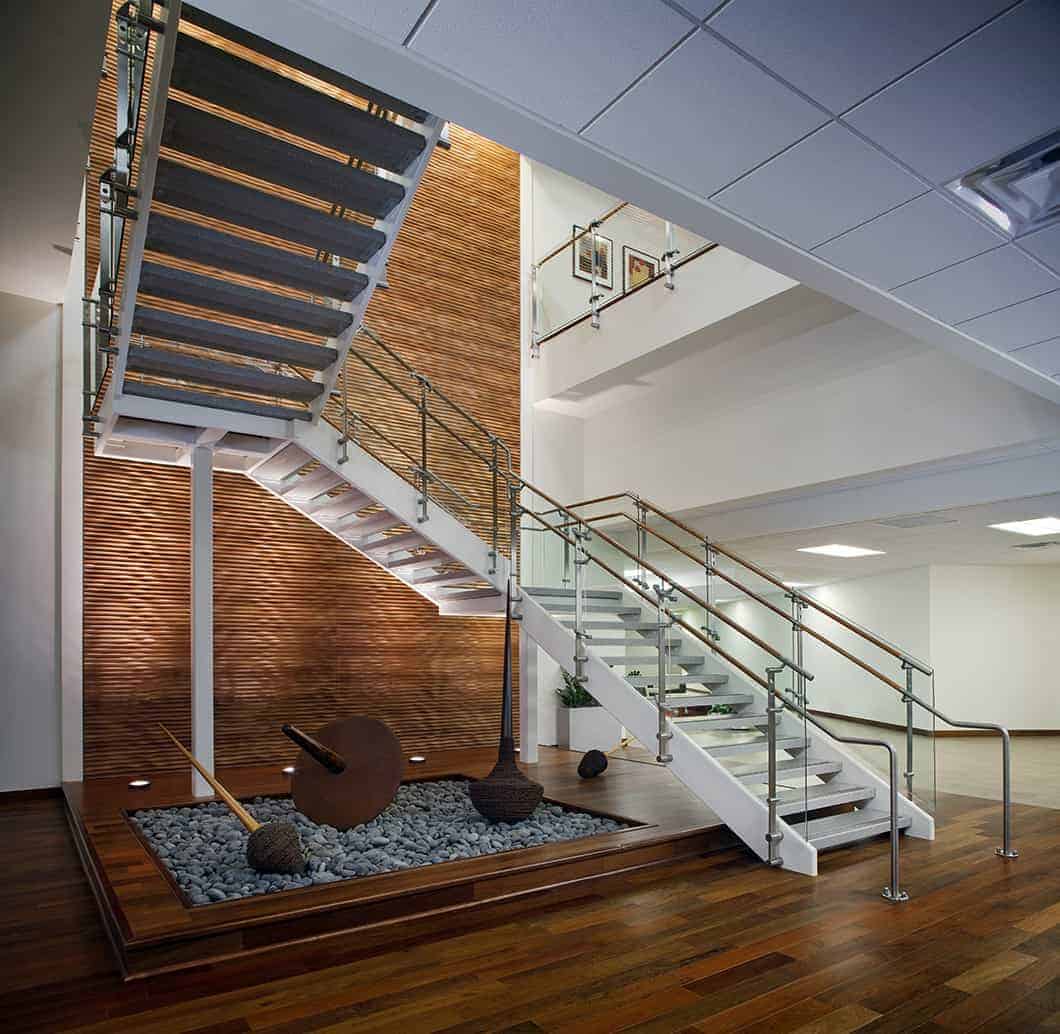Modern wooden staircase with rock garden feature.