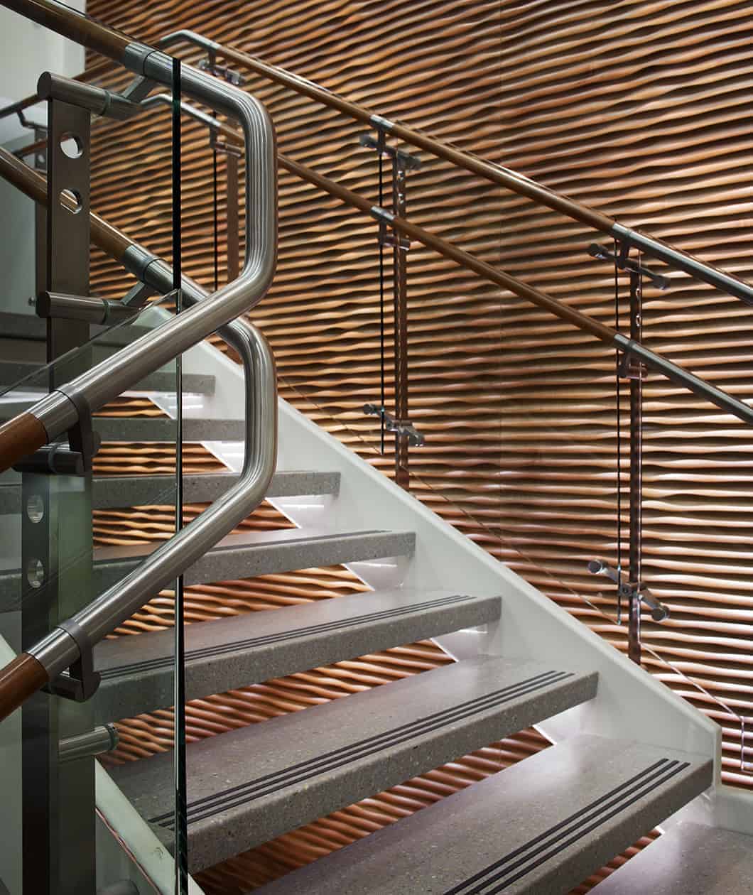 Modern staircase with wooden wave-patterned wall