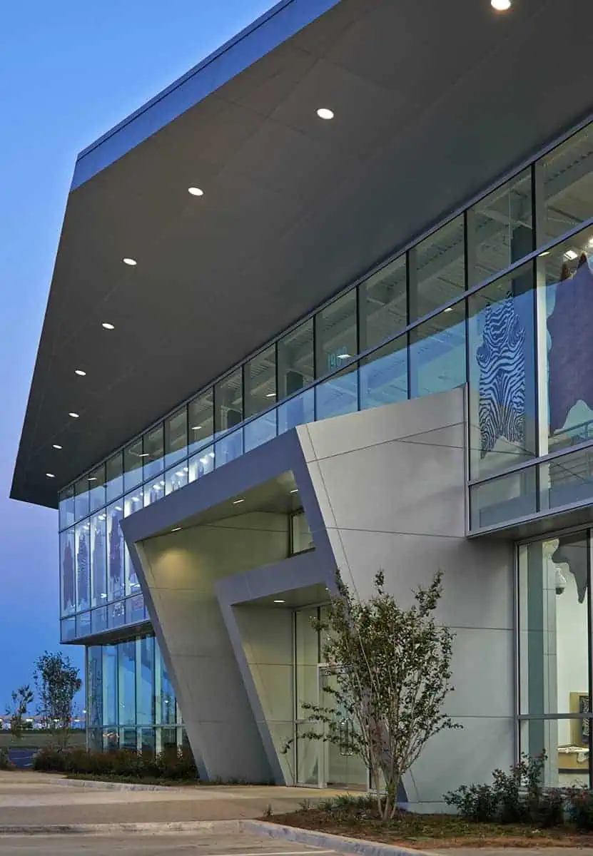 Modern building with glass facade at dusk.