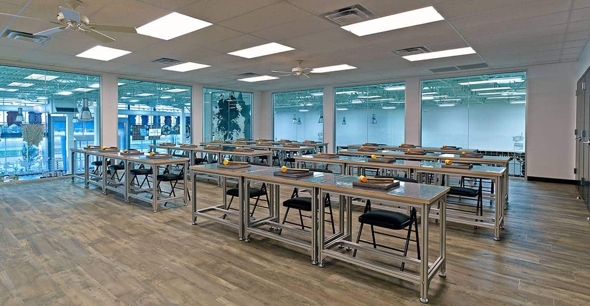 Modern classroom with metal tables and chairs.