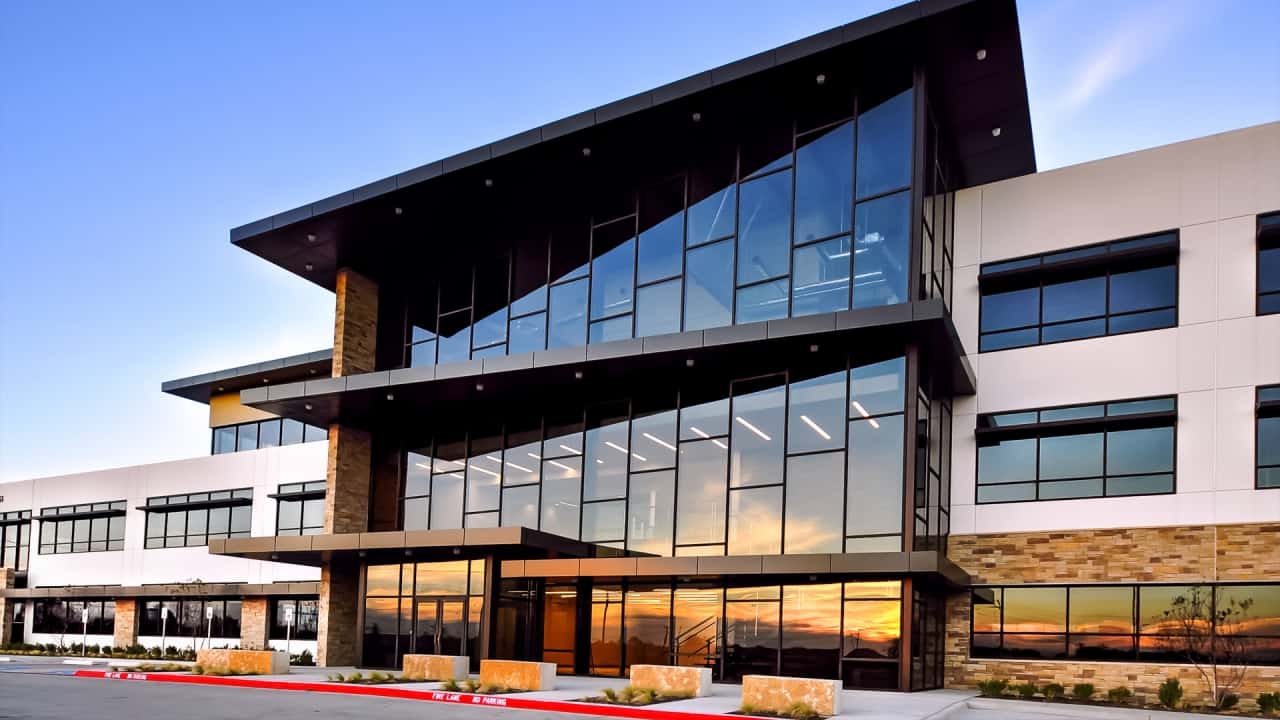 Modern office building with sunset reflection