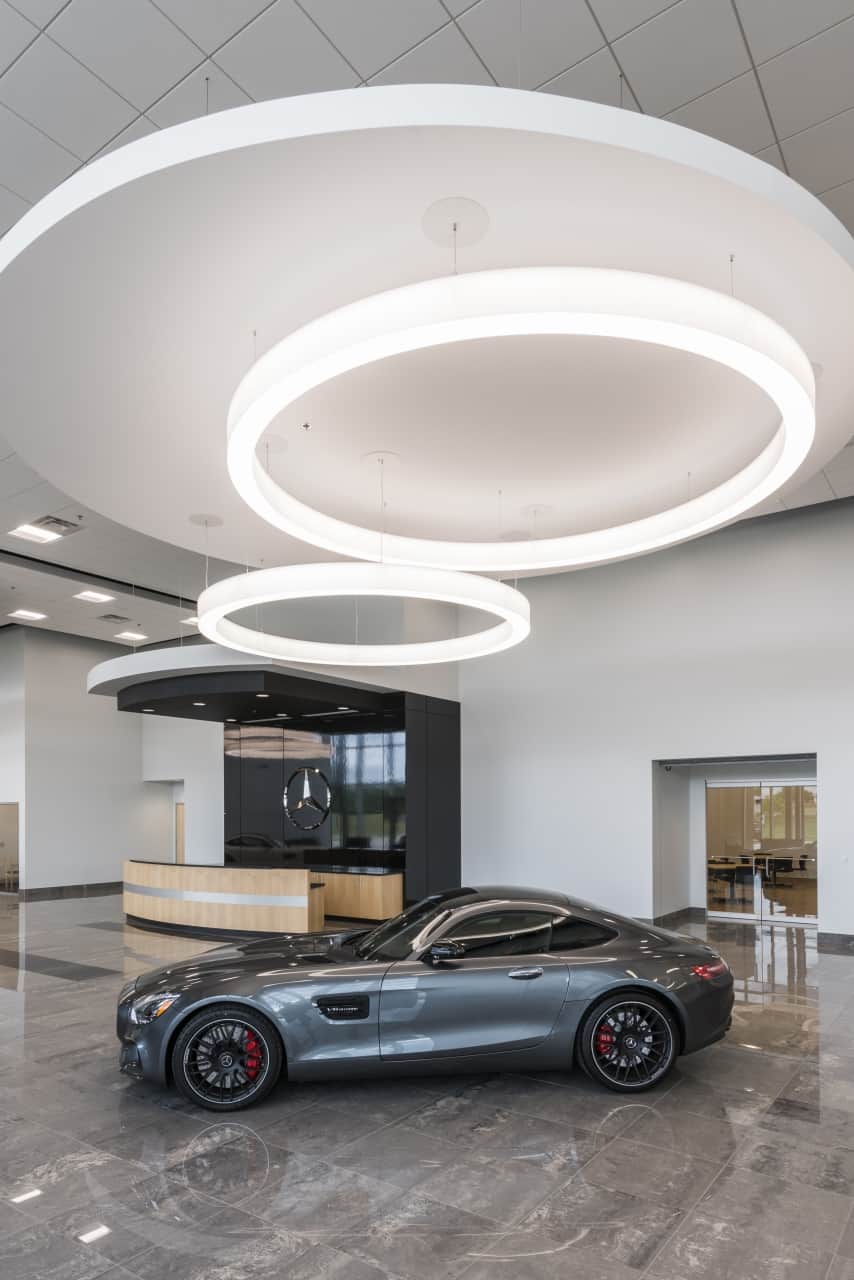 Luxury car displayed in dealership showroom.