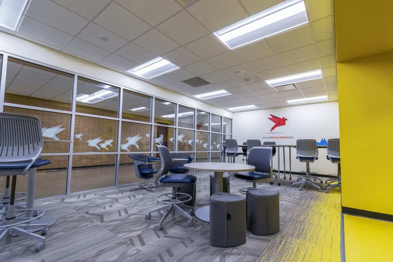 Modern office space with seating and bright colors.