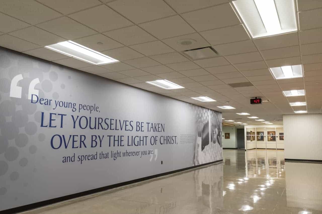 Inspirational quote on hallway wall about Christ's light.