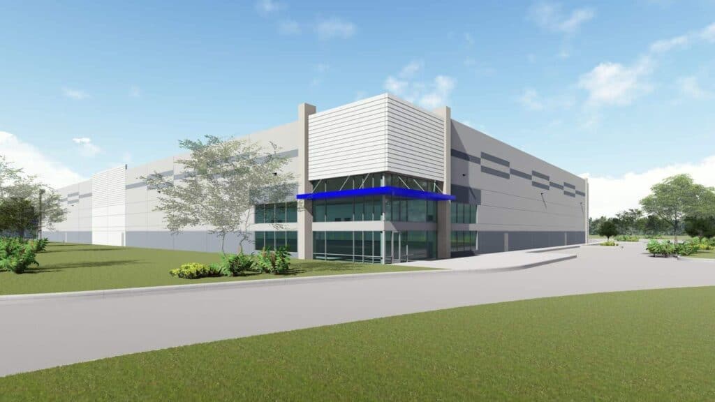 Modern industrial building with blue accents, sunny day.