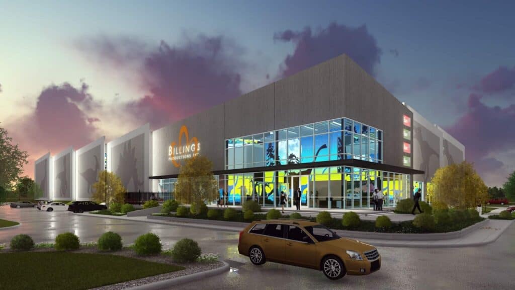 Modern building with colorful windows at sunset.