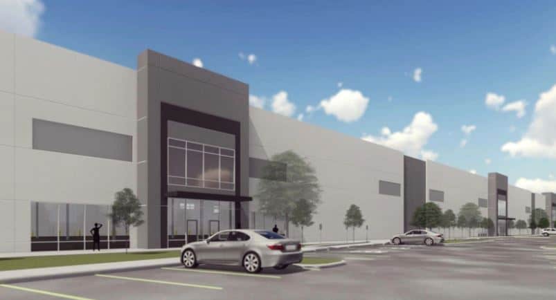 Modern industrial building with parked cars