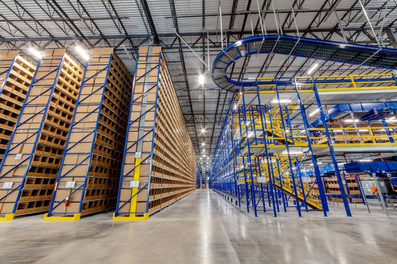 Modern warehouse with tall blue shelving units.