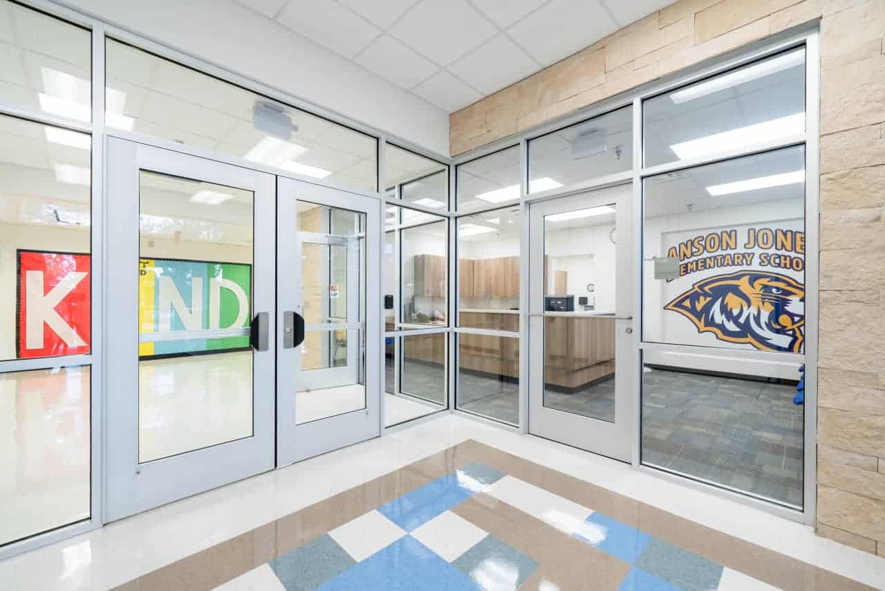 School entrance with KIND mural and logo.