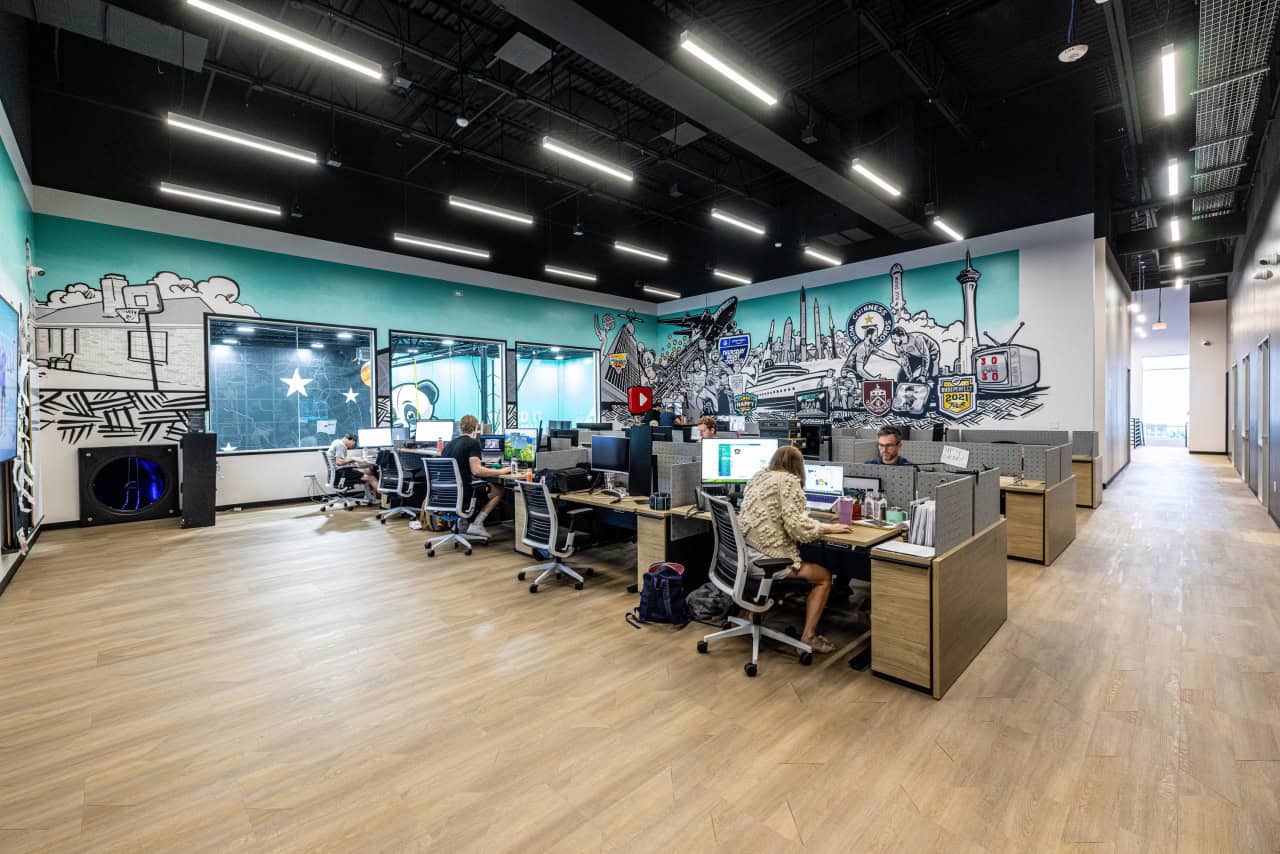 Open office with mural and workers at desks