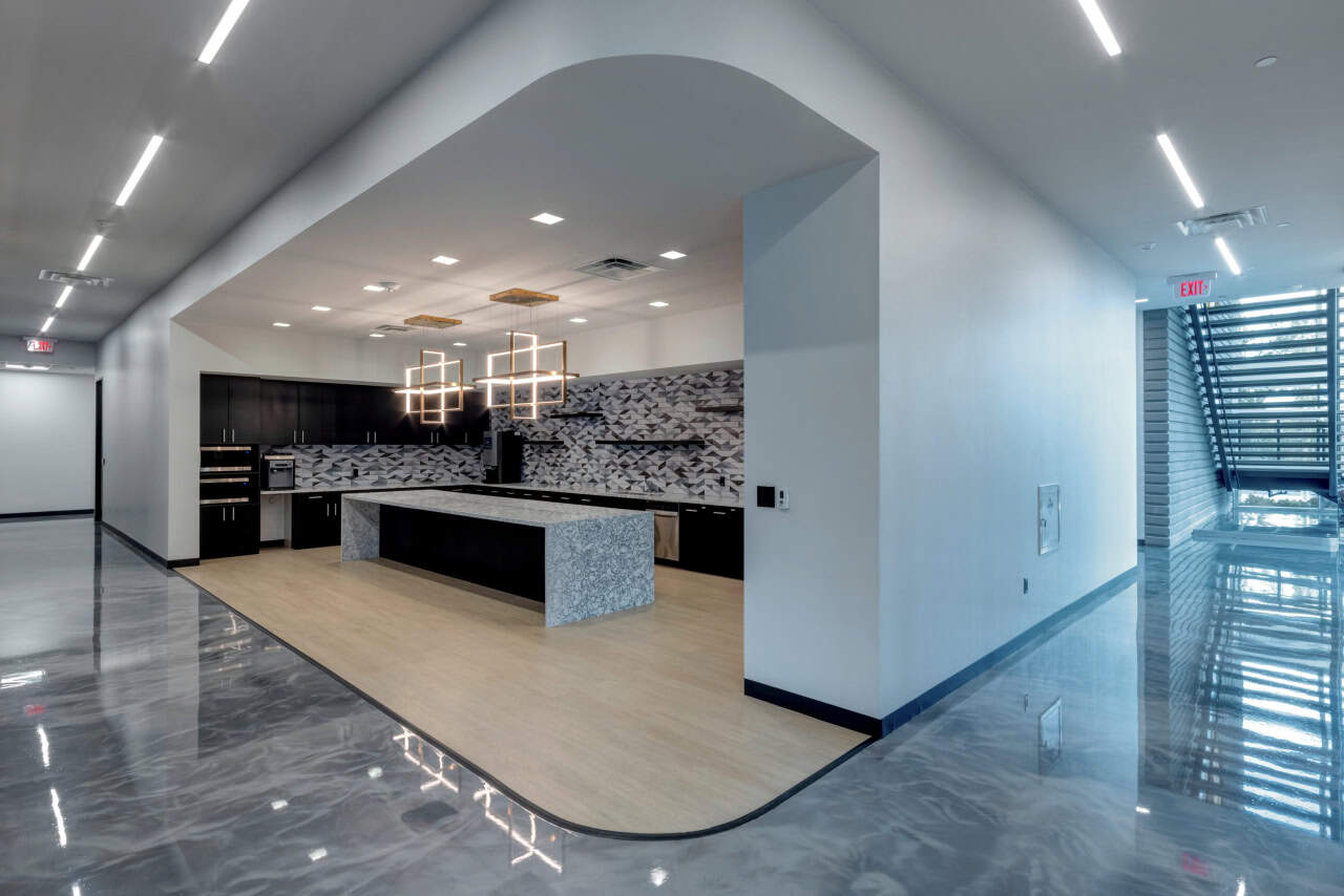 Modern office interior with kitchen and staircase