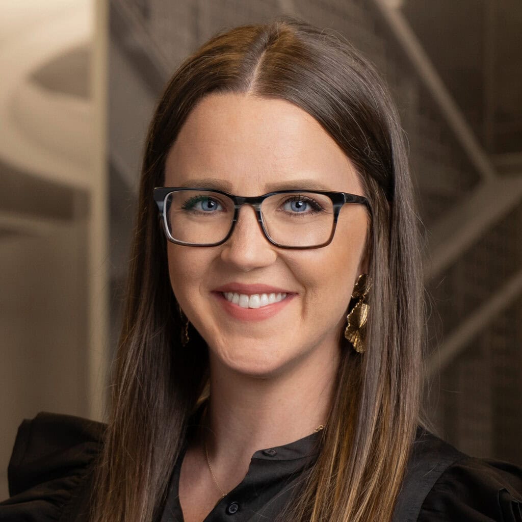 Woman smiling with glasses and long hair