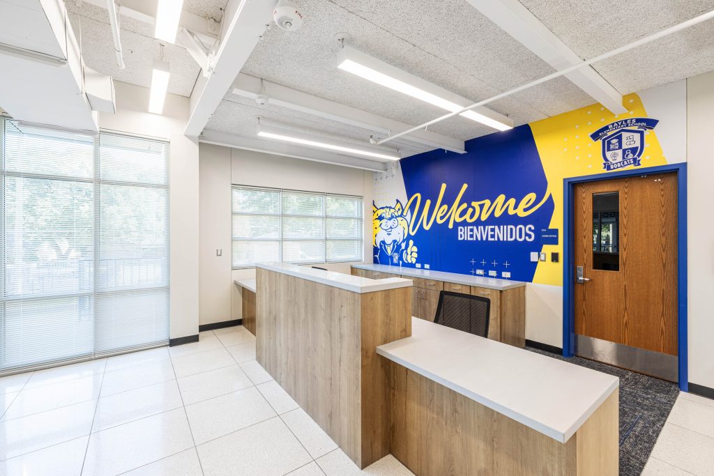 School welcome area with 'Welcome' mural.