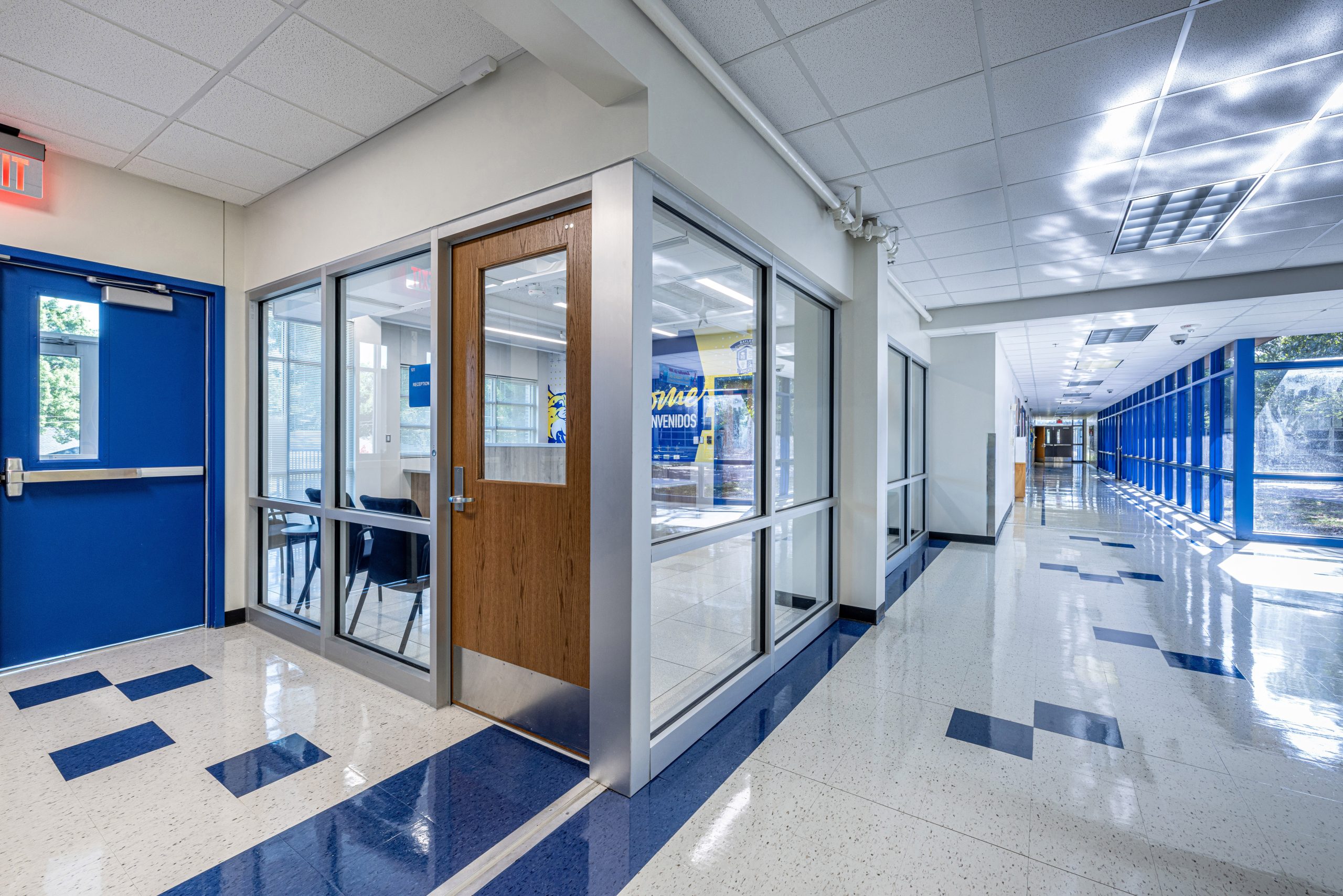 Bright school hallway with glass doors and windows.