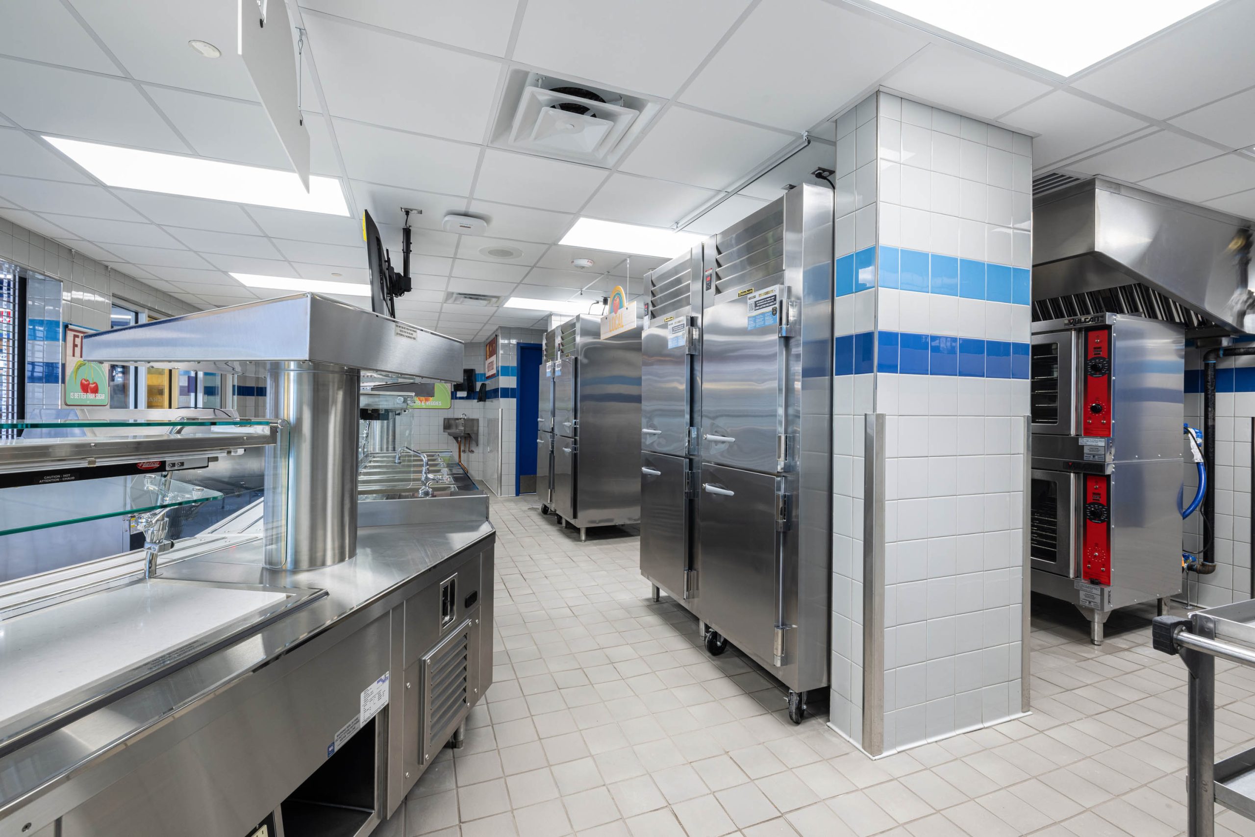 Commercial kitchen with stainless steel appliances.