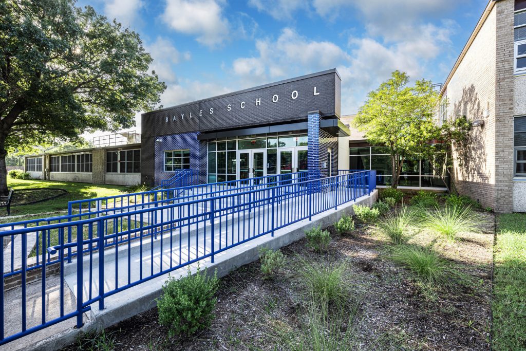 Bayles School entrance with blue accessibility ramp.
